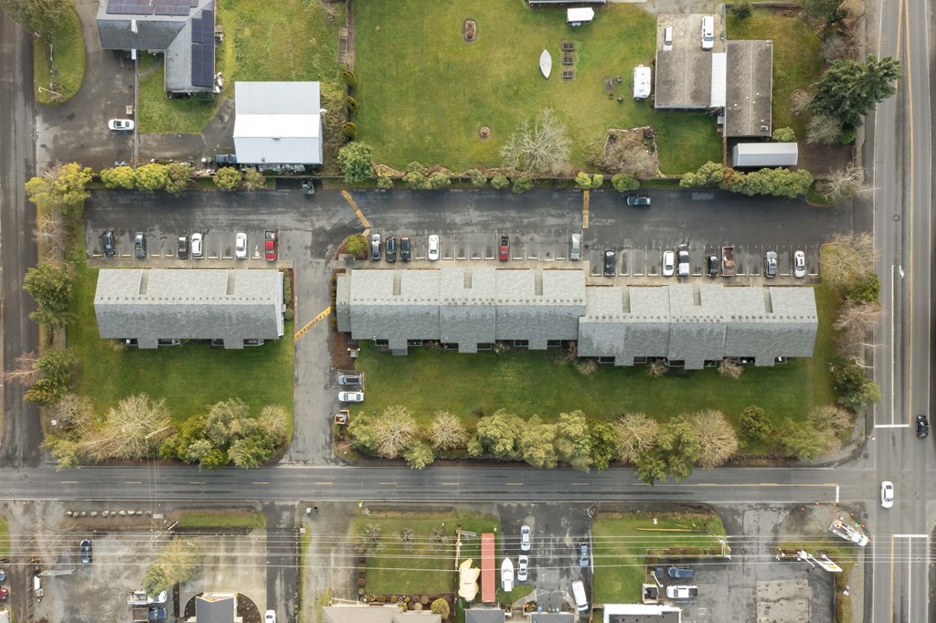 an aerial view of a building with a parking lot