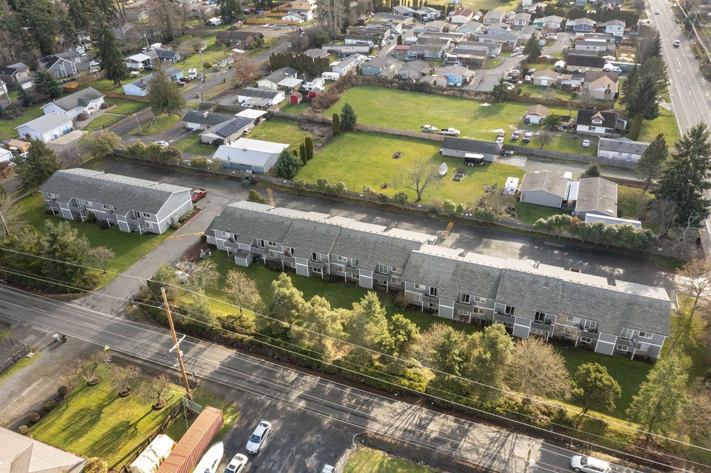 an aerial view of a neighborhood with houses and a green field