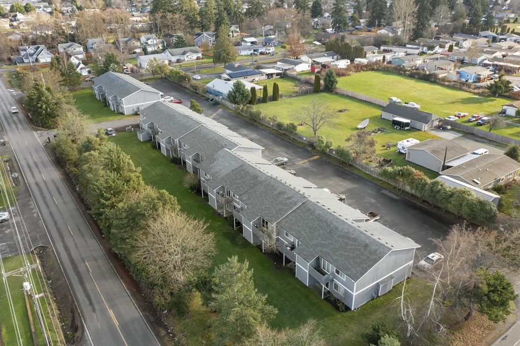 an aerial view of a building with a gray roof