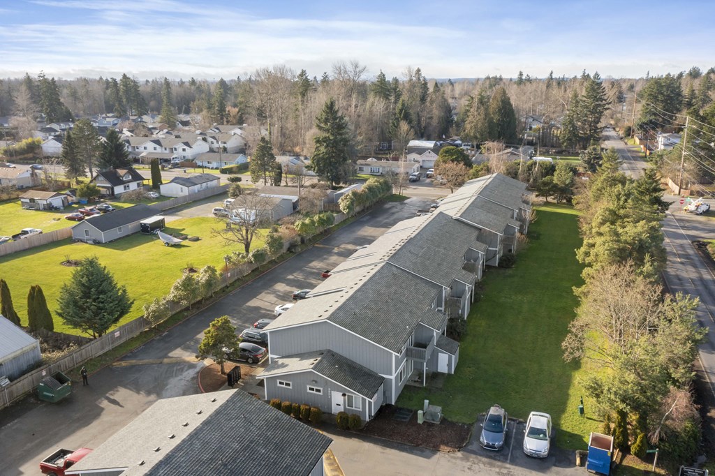 an aerial view of a church and a neighborhood of houses