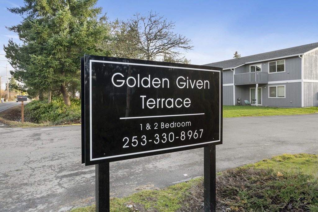 a sign for golden give terrace in front of a building