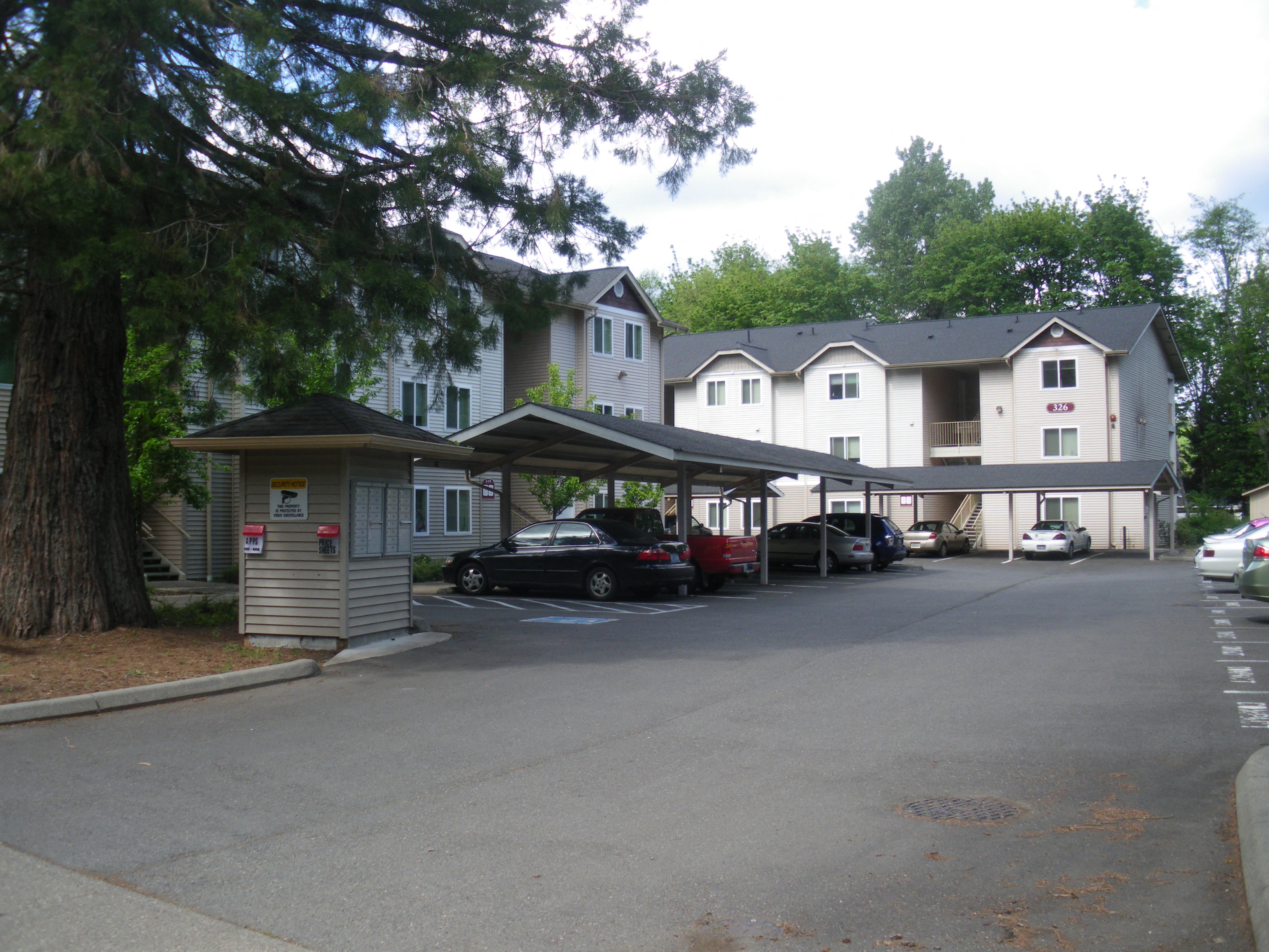 a parking lot with cars parked in front of a building