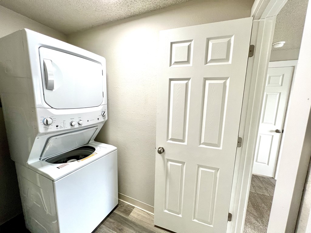 A white oven and stove in a small room.