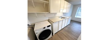 A small laundry room with a washer and dryer.