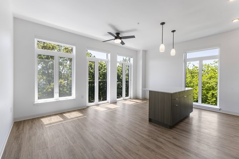 A spacious room with a ceiling fan and sliding glass doors at The Hub Apartments, Washington 98503