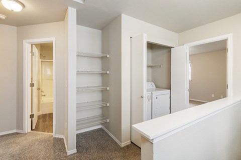 a bedroom with a closet and a mirrored door to a bathroom