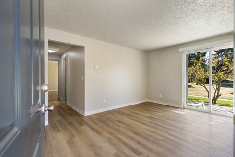 A room with a wooden floor and white walls.