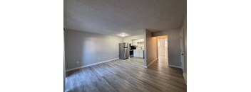 A kitchen area with a refrigerator, microwave, and oven.