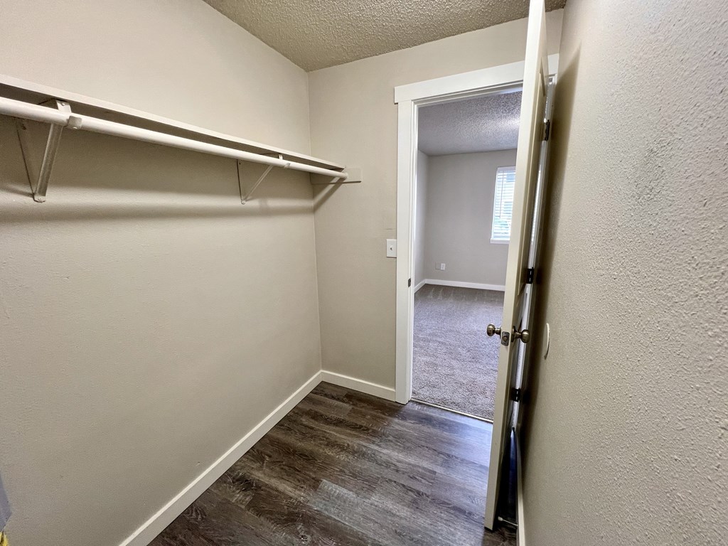 A room with a white door and a white wall.