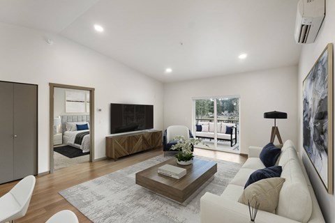 A modern living room with a white sofa, a coffee table, and a large painting on the wall.