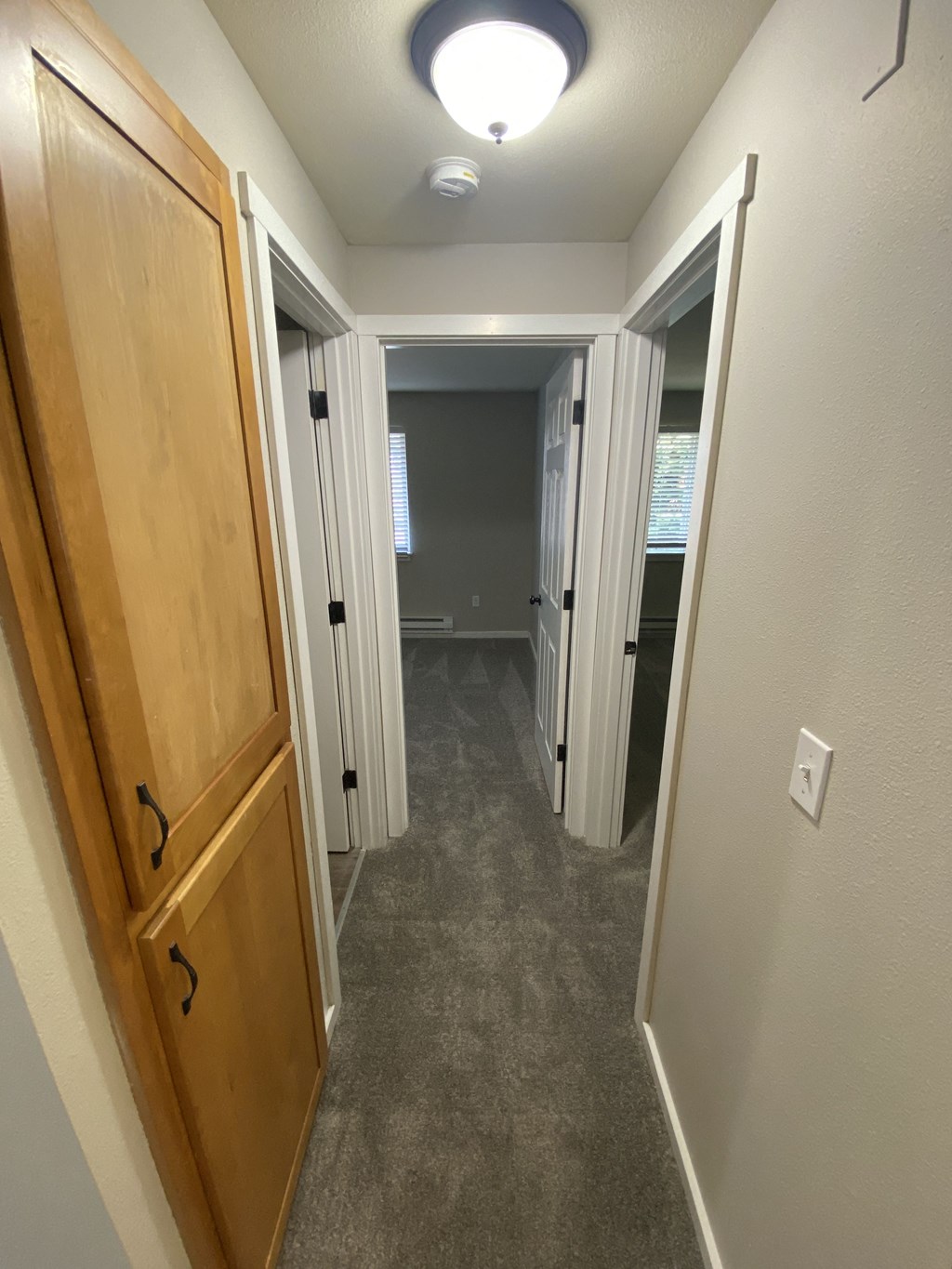 a bedroom with a closet and a door open to a hallway with two closets