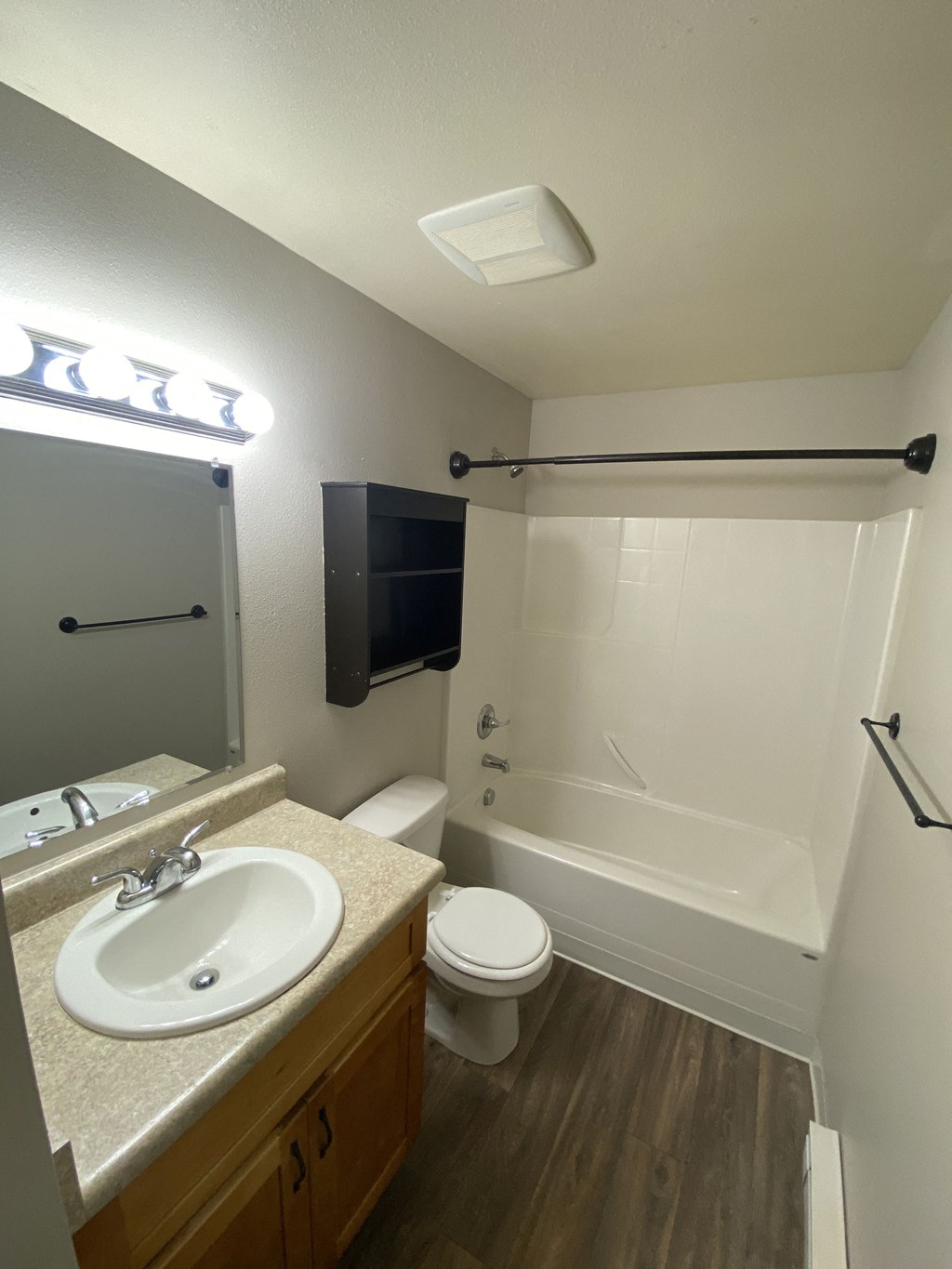 an empty bathroom with a sink toilet and shower