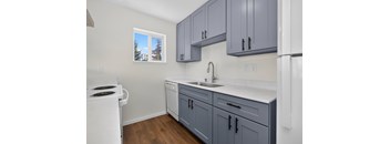 A kitchen with a white stove and a white refrigerator.