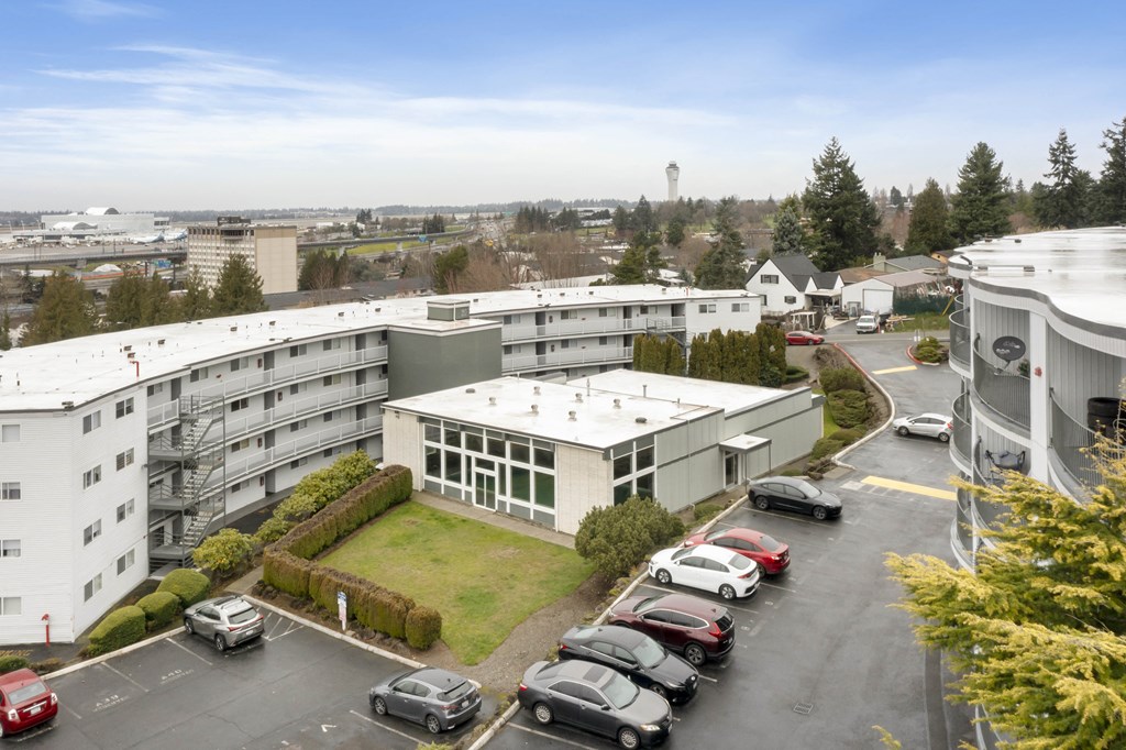 an aerial view of an office building with cars parked in a parking lot