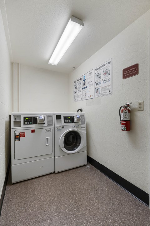 a laundry room with a washer and a washing machine