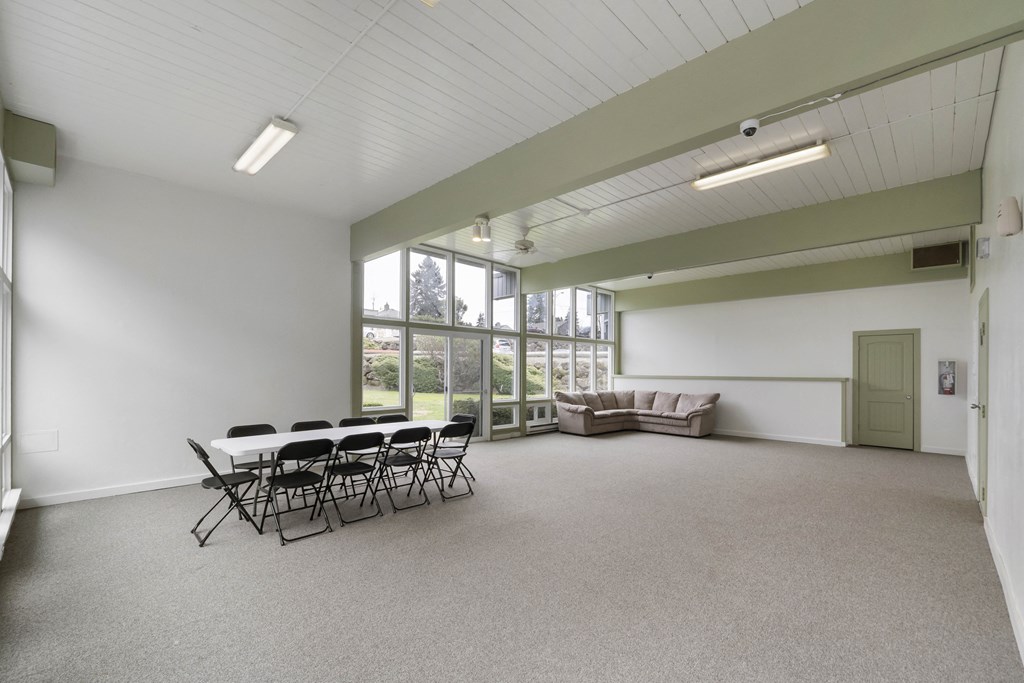 a large room with a table and chairs and a couch