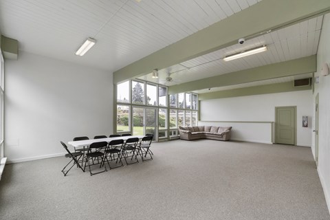 a large room with a table and chairs and a couch