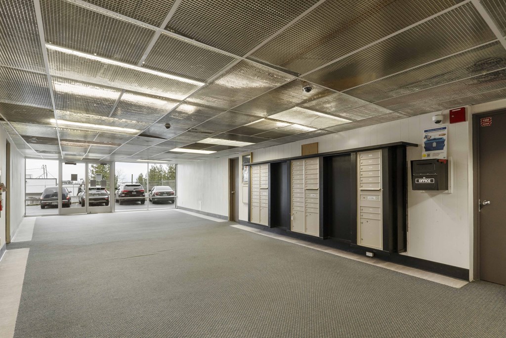 the lobby of a parking garage with cars parked in it
