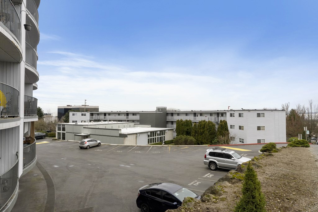 an office building with cars parked in a parking lot