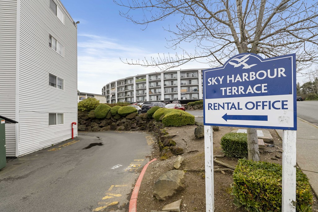 a sign for the sky harbour terrace rental office in front of a building