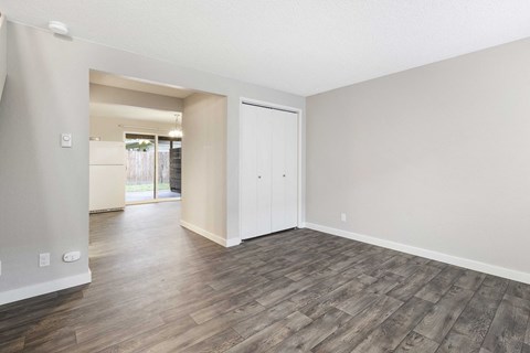 the spacious living room and dining room with wood flooring