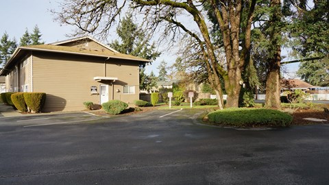 A building with a parking lot in front of it.