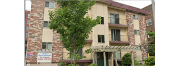 Apartment building with a sign that says "Goss Apartments for Rent".