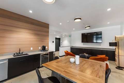 A modern kitchen with a wooden table and chairs.