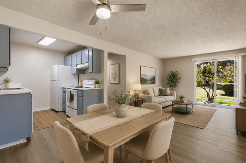 A modern kitchen with a dining table and chairs.