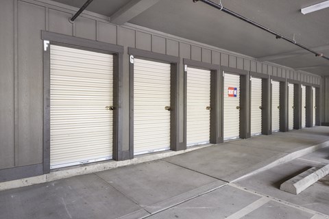 A long row of garage doors are closed.