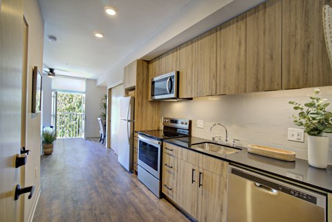 a kitchen with wooden cabinets and stainless steel appliances
