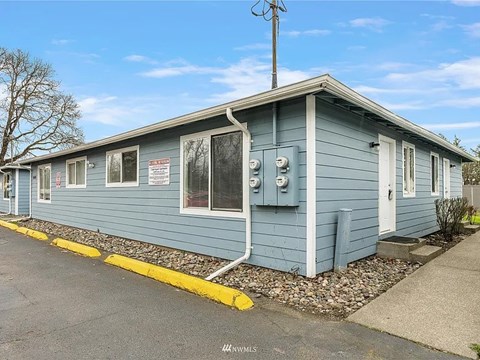 A blue building with a yellow line in front.