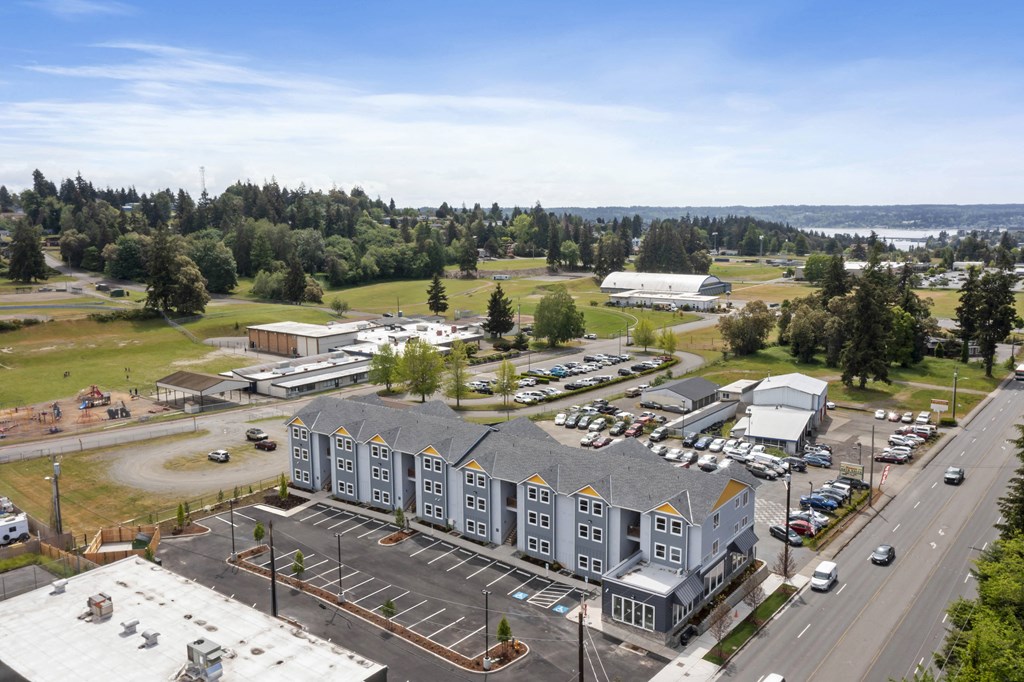 an aerial view of an apartment building and parking lot