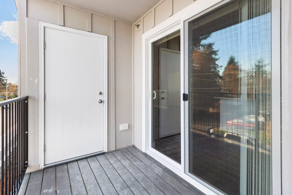 the deck of a condo with a door to the patio