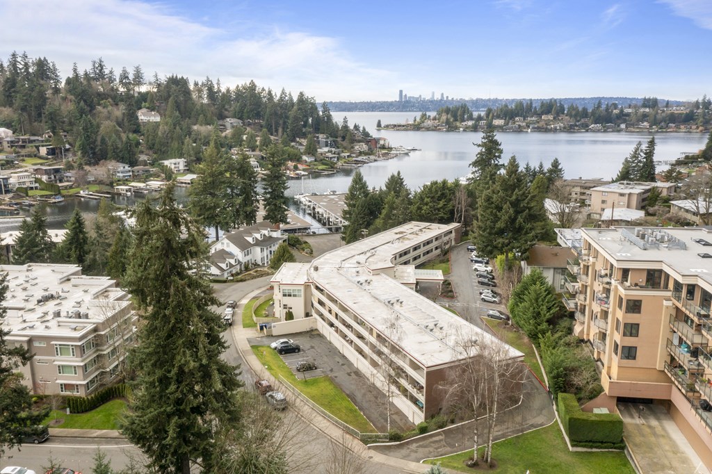 an aerial view of a building overlooking a city and a lake