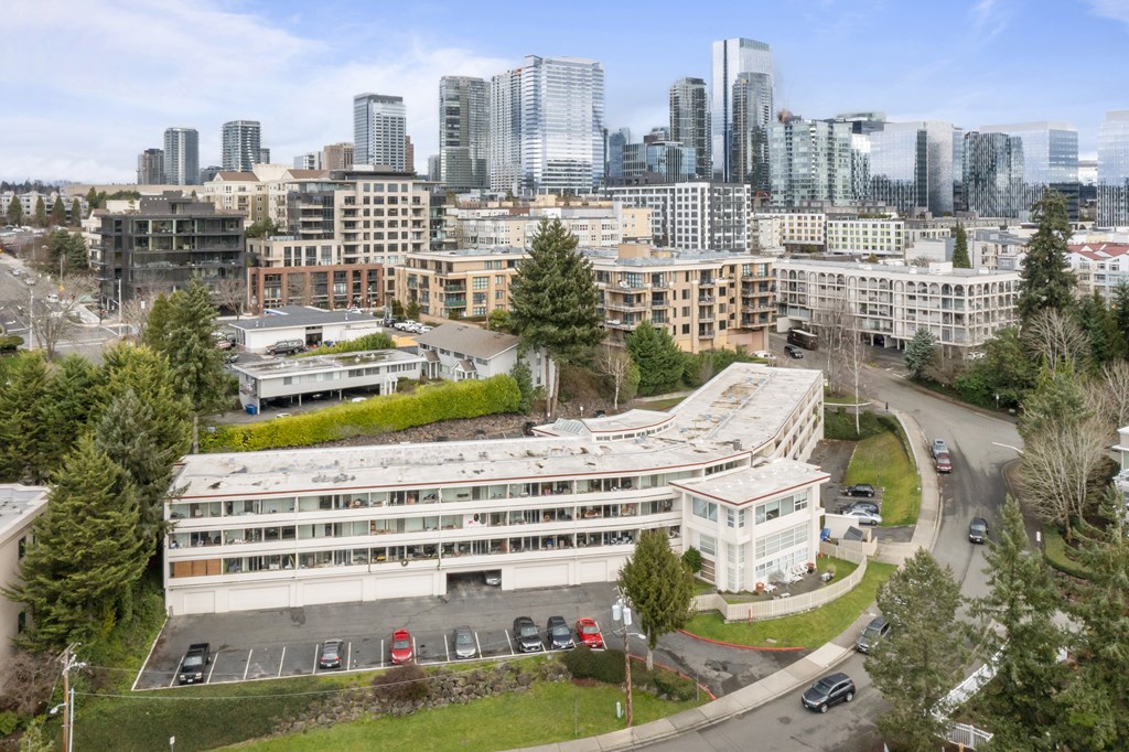 an aerial view of a building with a city in the background