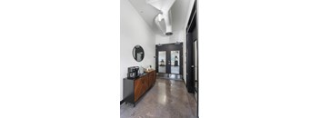 A modern kitchen with a black countertop and a wooden cabinet.