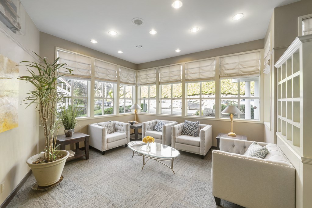 a living room with couches and chairs and a table
