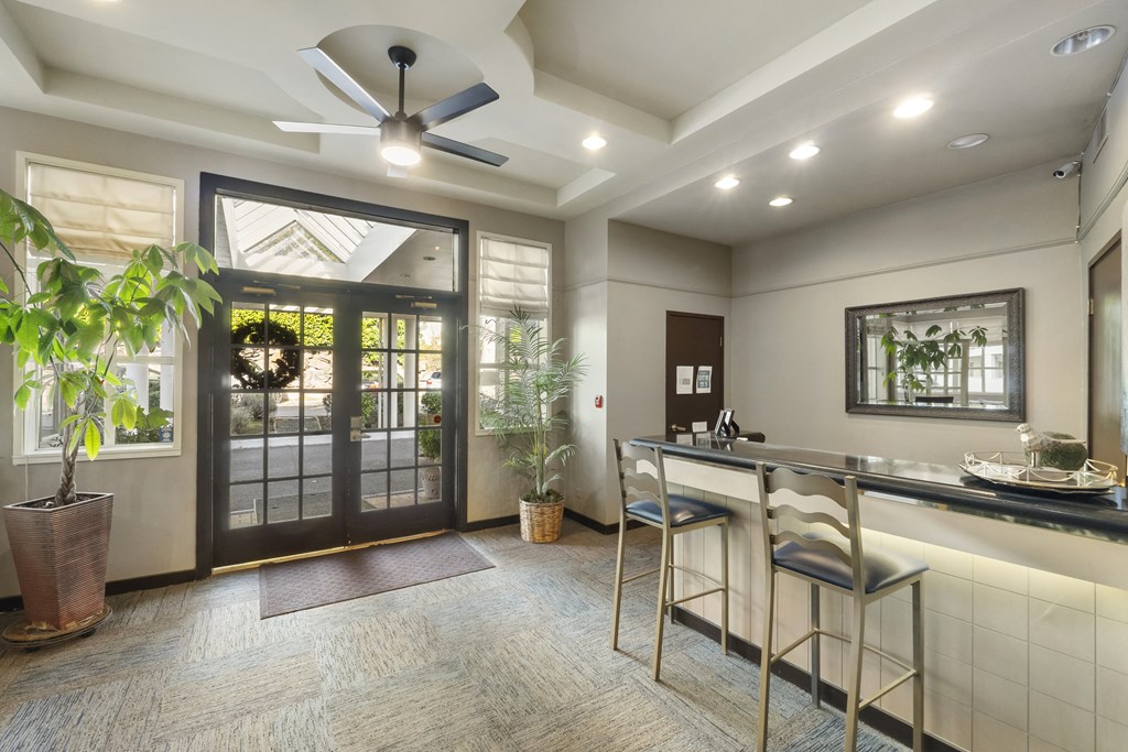 a kitchen with a bar and a door to a patio