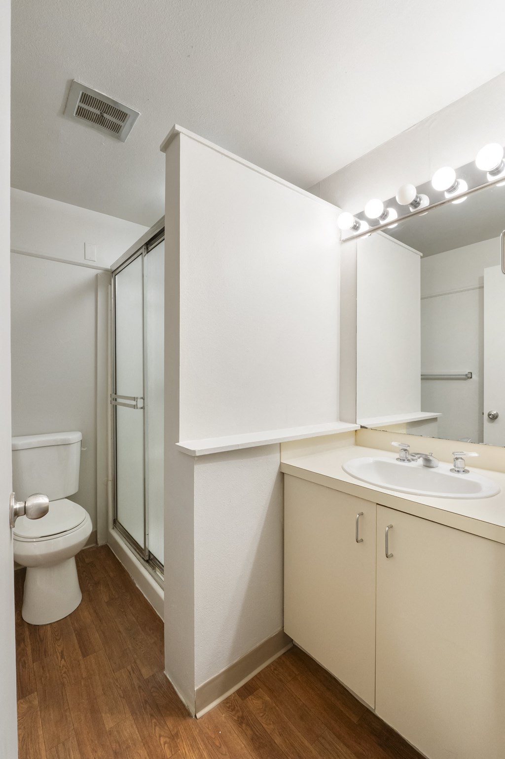 a bathroom with a toilet sink and a shower