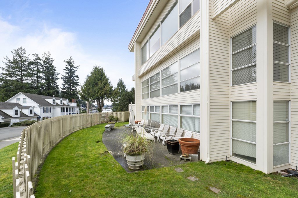 the back of a house with a yard and a fence