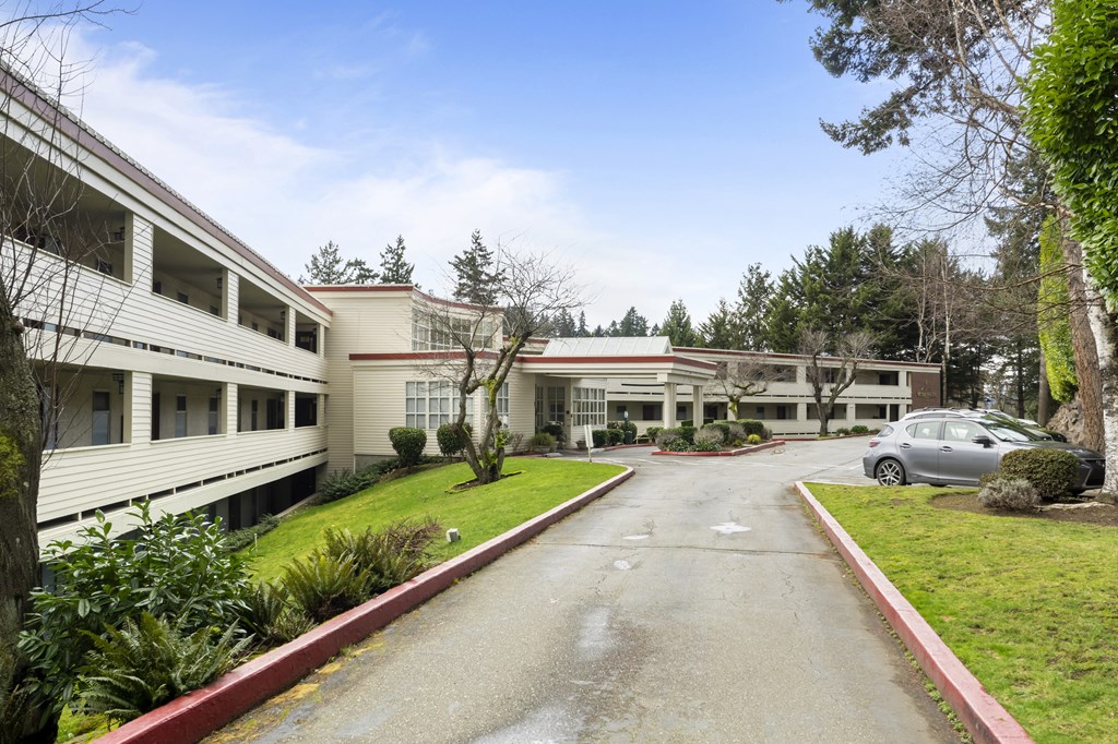 the exterior of a building with a car parked in front of it