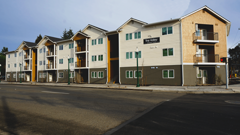 The image shows a street view of apartment buildings with the name "The Valley" on the front.