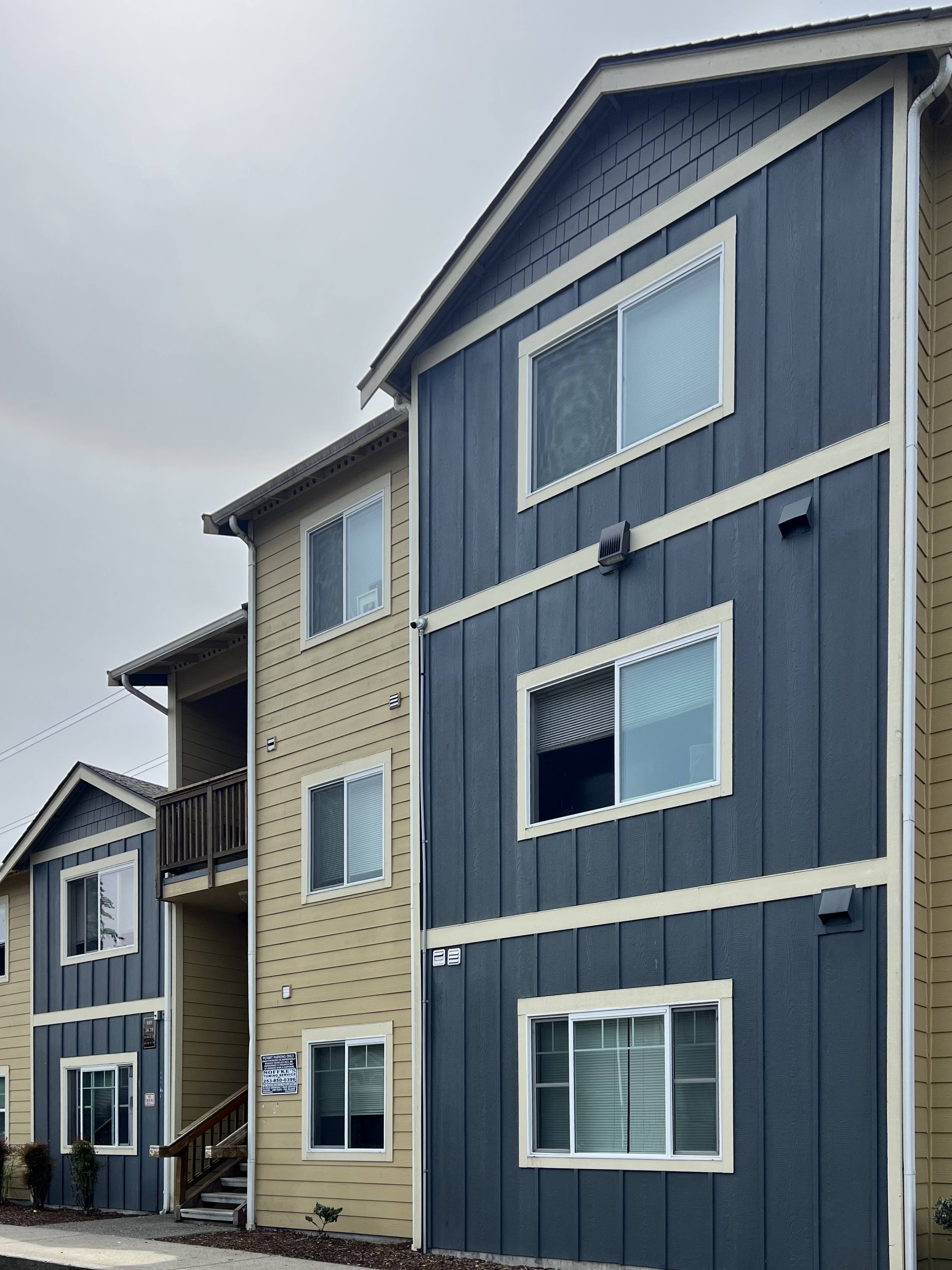 Blue and tan painted Legacy Ridge Apartments in Tacoma, WA