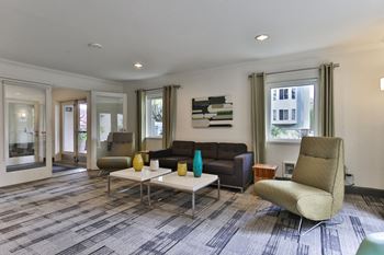 a living room with couches and chairs and a table