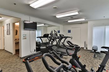 a room filled with cardio bikes and a tv