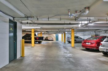 a parking garage filled with cars and cans of beer