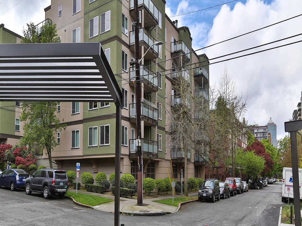 an apartment building with cars parked in front of it