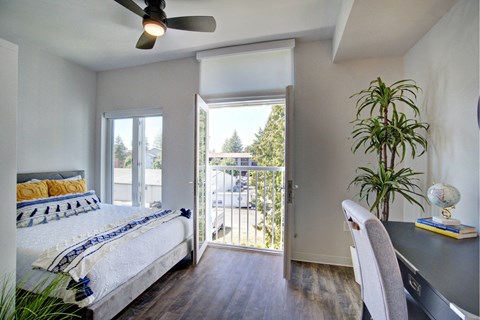 A bedroom with a bed, desk, and chair at The Hub Apartments, Lacey