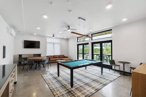 A room with a pool table and a television at The Hub Apartments, Lacey, WA